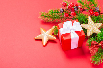 Christmas red background with herringbone and decor. Gold and red jewelry. Top view with space for copy.
