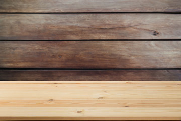 Wooden  table in front of a blurred background. Perspective brown wood over blurred wooden planks background - can be used to showcase or assemble your products. Mock up to display the product.