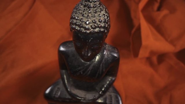 Close up macro panning shot of Buddha statue