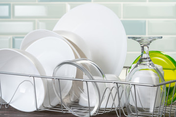 Dish rack with clean dry dishes on kitchen counter