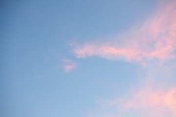 Low angle shot of the calm sky in pastel shades with a few clouds