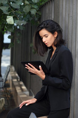 Business woman with tablet pc outdoor posing