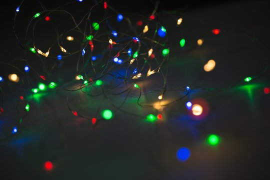 Christmas lights on dark background with copy space. Decorative garland