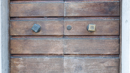 amazing close up of old wooden door with old rustic square handle