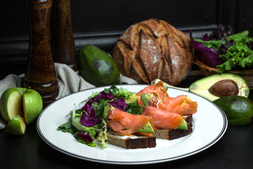 smoked salmon bruschetta with avocado and cream cheese served with salad