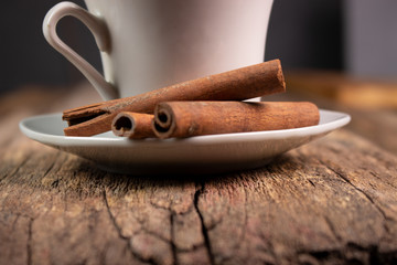 Tea with cinnamon flavor on an old wooden board