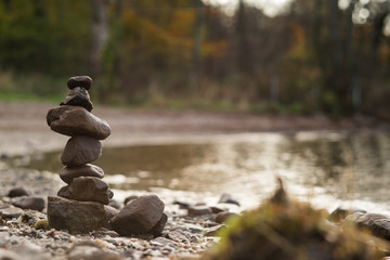 a small cairn made of smooth pebbles on the beach of Loch Lomond Scotland