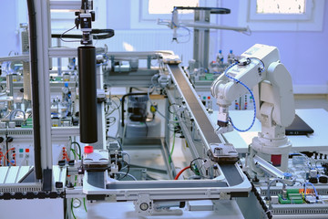 Industry 4.0 concept; artificial intelligence in smart factory prototype. Robot picks up the...