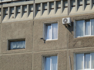 Soviet architecture. Ust-Kamenogorsk (Kazakhstan) Apartment building. Soviet architectural style. Residential building. Soviet built multistory apartment building. Building closeup. CCTV