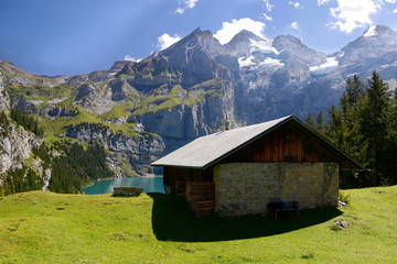 Fototapeta na wymiar Idyllic hut on swiss alps lake