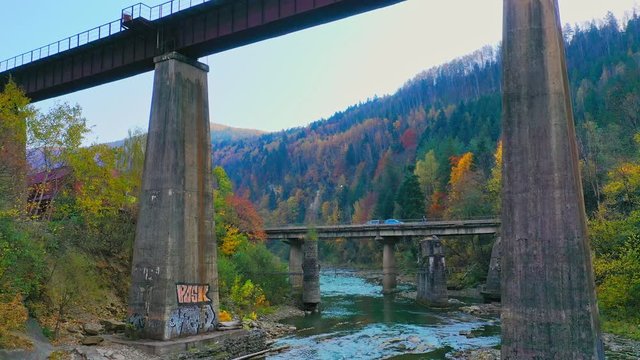 Aerial Drone video flying over railway bridge in Carpathians mountains, Yaremche, Ukraine
