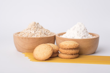 Close up of oat flake and wheat flour prepared for cooking on a white background