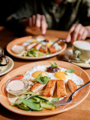Fried eggs with chicken breast breaded. breakfast