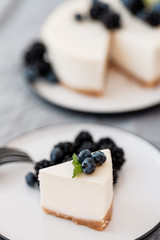 Homemade cheesecake with fresh berries. a piece of cheesecake with a blackberry in the foreground