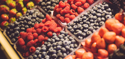Fresh wild berries (raspberries, blueberries, strawberries) at the fruit market