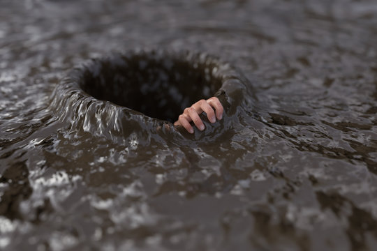 human hand clings to the edge of a hole