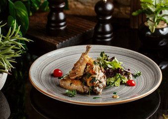 roasted chicken wings served with fresh lettuce salad and cherry tomato
