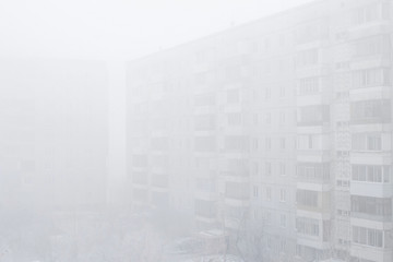 Very dense fog, window view of neighboring houses on a foggy win