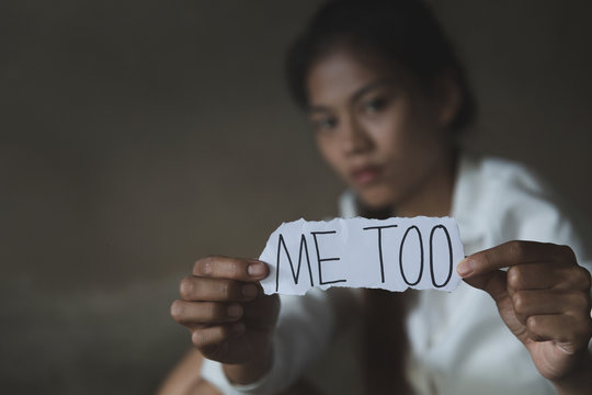 women sitting alone with depressed expression and showing a paper with a metoo text. #metoo as a new movement. Ideas to stop violence against women, sexual harassment and rape, human trafficking