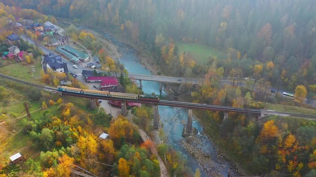 Aerial Drone video flying over railway bridge in Carpathians mountains, Yaremche, Ukraine