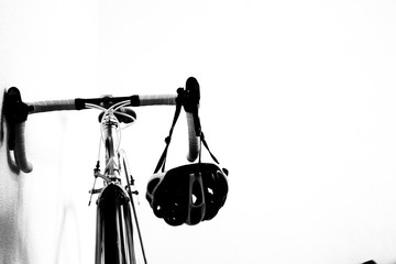 black and white photo of a steering wheel of a sports bike with a helmet