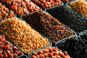 Dried berries on the counter. Raisins, dried apricots, prunes. Vegan food