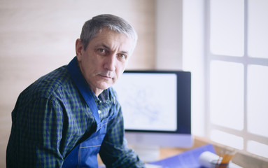 Engineer carpenter working on laptop and sketching project