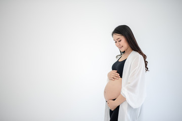 Beautiful young women in the third trimester of pregnancy Pregnant woman holding arms in her...