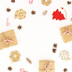 Christmas gifts, decorations and candy canes on white. Flat lay, top view. New year composition