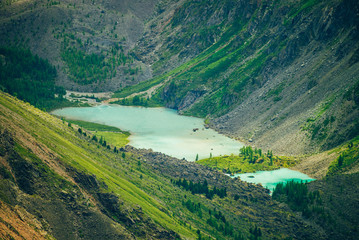 Naklejka premium Aerial spectacular view to scenic valley with two beautiful mountain lakes, conifer forest and rocky mountains. Amazing atmospheric highland landscape. Wonderful majestic wilderness nature scenery.