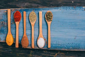 flat lay of spices in wooden spoon on table