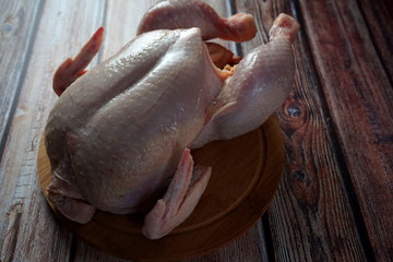 Fresh chicken on cutting Board on wooden background Healthy food, proteins