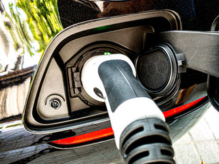 EV Car or Electric car charging at charging station