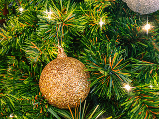 Christmas decoration composed of fresh fir branches and ornaments in golden