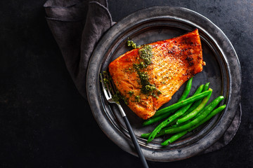 Closeup of baked salmon fish with green beans