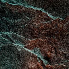 A natural background made of multi-colored wild stone close-up. View from above