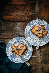 Banana cake in blue plates on a rustic wooden table