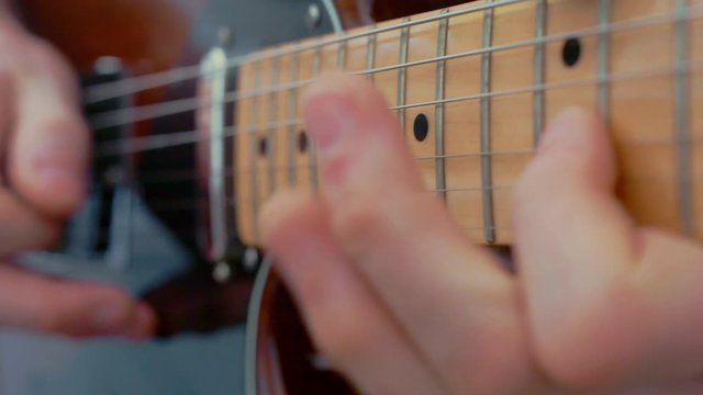 Close up playing electric guitar