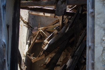 Fototapeta na wymiar collapsed roof of old abandoned house