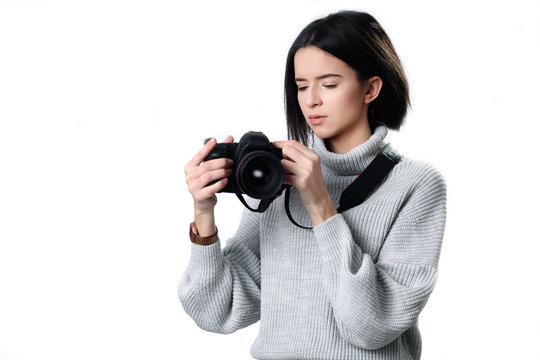 beautiful woman holding a photo camera. Isolated over white background