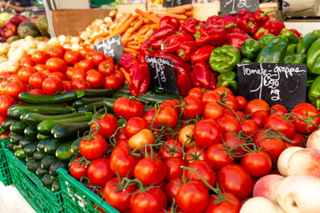 Bright fresh vegetables on a market counter. Products for vegetarianism and raw food diet. Background. Space for text.