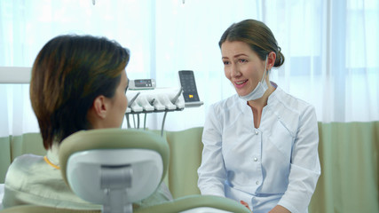 Dentist and woman have a serious conversation 