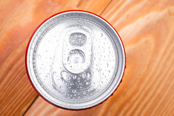 Can of soda lemonade with water drops in macro view