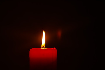 Candle flame on black background.