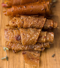 fruit rolls on a wooden board on a black background. Useful sweets. Proper nutrition. Sweet Sugar Free