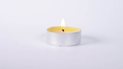 Fototapeta na wymiar Decorative candle on the table, white background