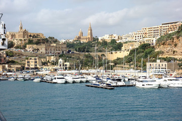 View from the sea of the port of Gozo with the Parish Church of Our Lady of Loreto, Roman Catholic...