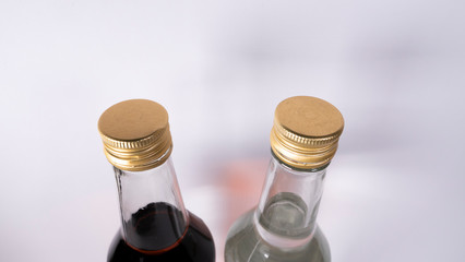 Bottles with cognac, whiskey and vodka on a white background