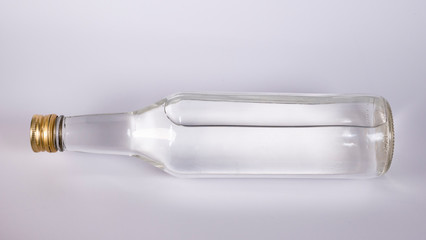 Bottle with a clear liquid, vodka on a white background