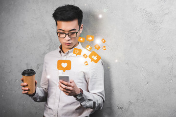 asian seo manager holding paper cup, using smartphone with likes illustration